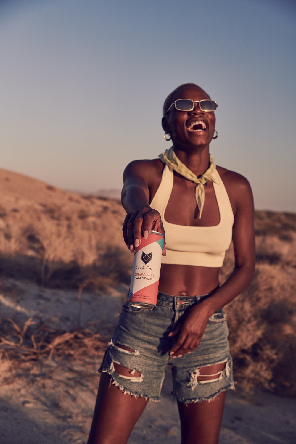 Ashley Byrd holds a Grapefruit can of Cool Cat wine spritzer in the desert.