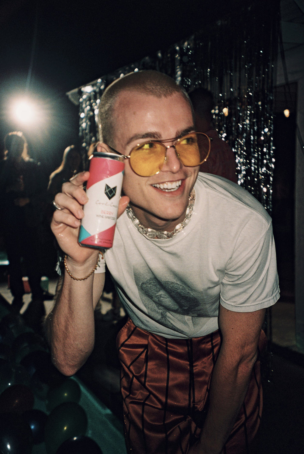Dakota Griffin is photographed holding a can of Berry Cool Cat Wine Spritzer cocktail.