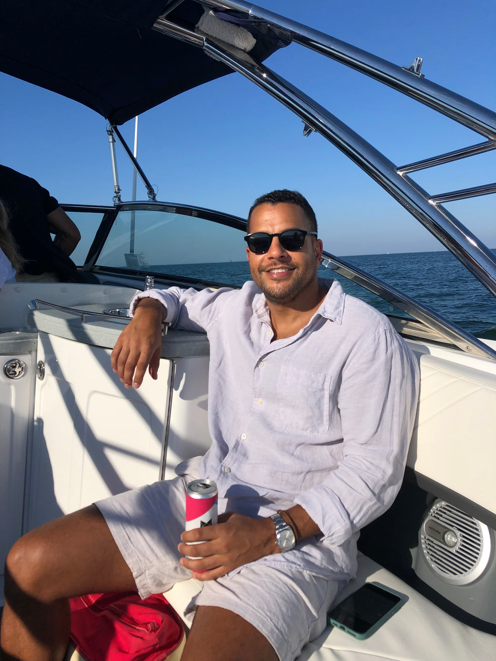 Cool Cat’s Co-Founder Rocco Venneri drinking a canned spritzer on a boat.