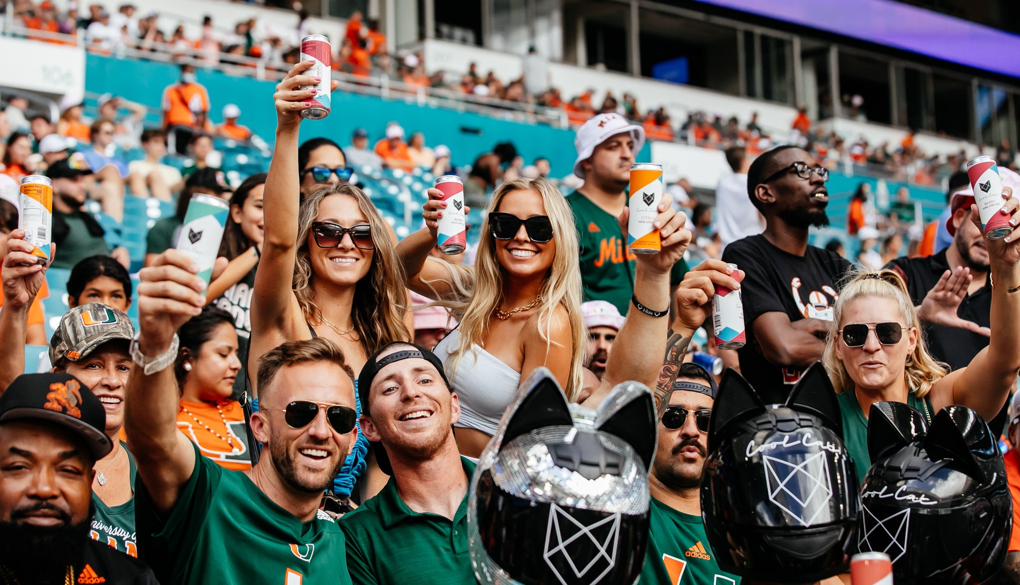 Fans of the University of Miami Hurricanes watch the game while holding Cool Cat Wine Spritzers.