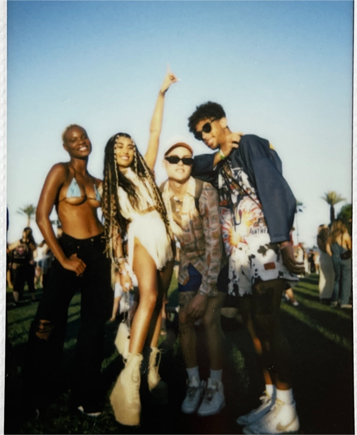 4 young people pose for the camera at Coachella.