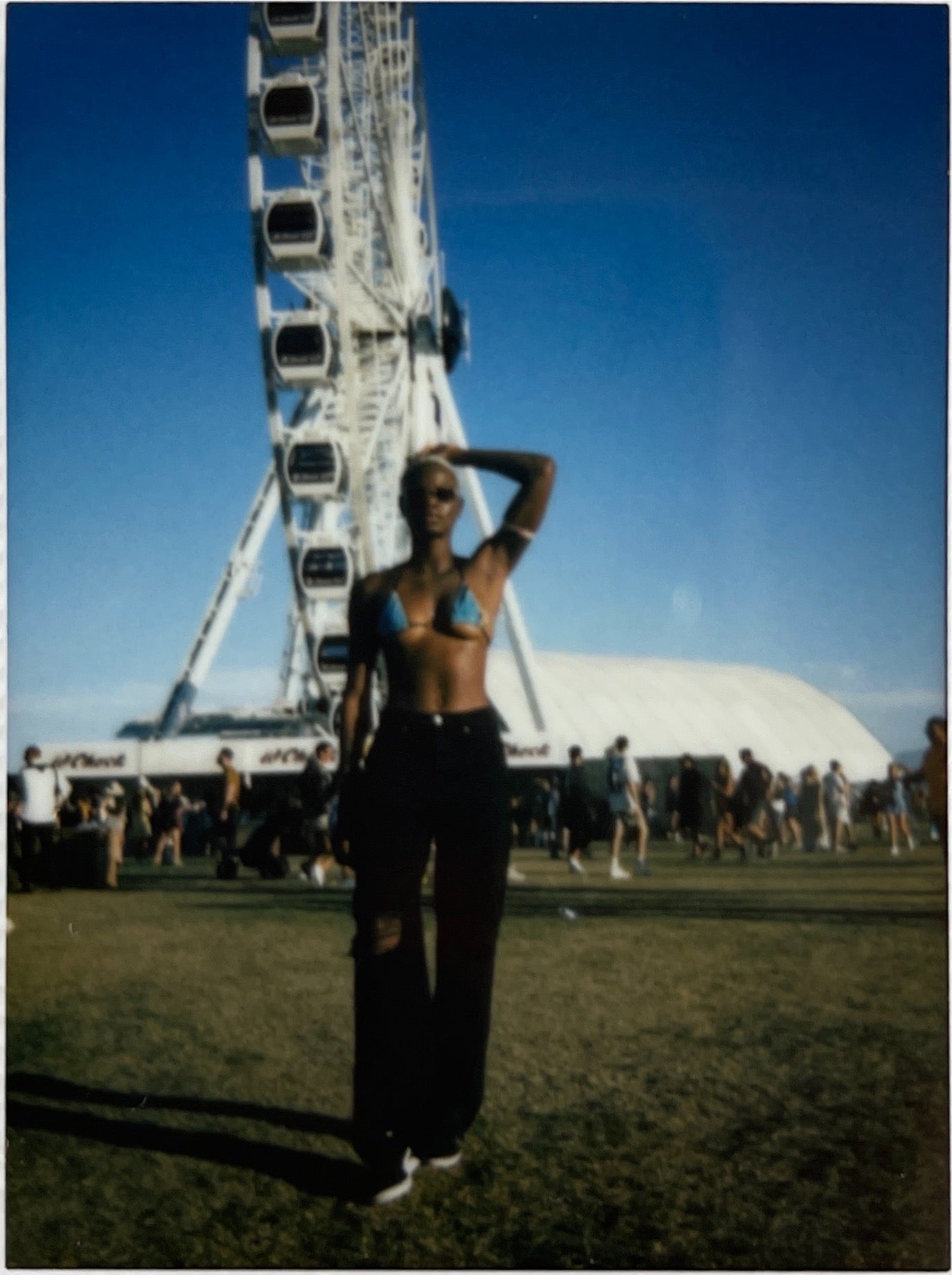 Polaroid of young person at a festival.