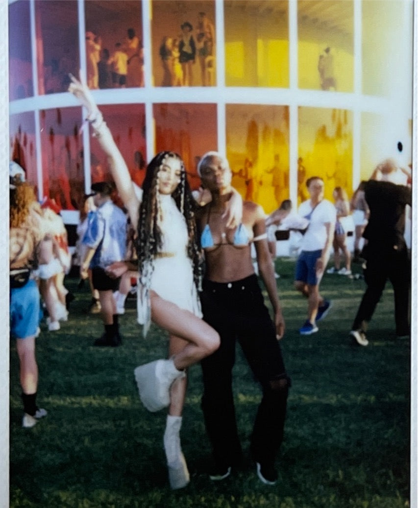 Polaroid of two young women at a festival.