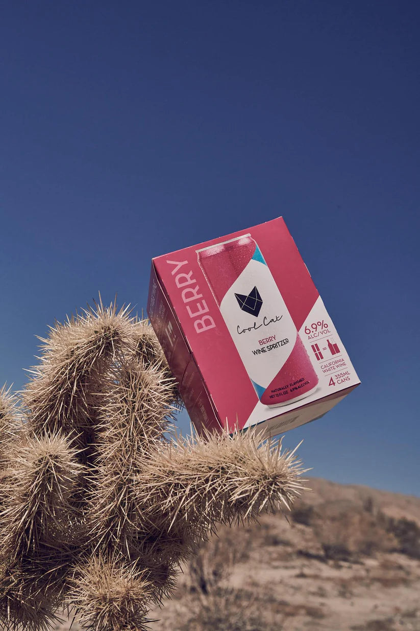 A 4-pack of Cool Cat Berry Cocktail in the desert.